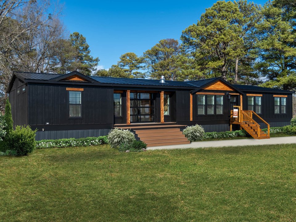 Modern double-wide manufactured home with landscaped exterior